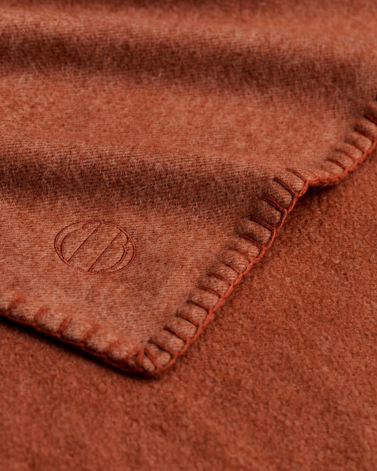 Cashmere throw with hand-stitched border